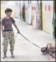Lynndie England humiliating an Iraqi prisoner